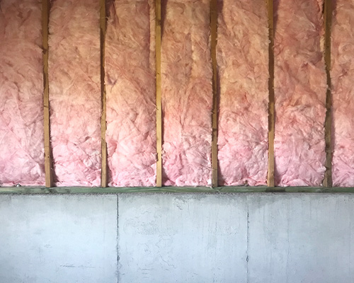 basement-insulation-hanover-pa Pink insulation in an unfinished basement.