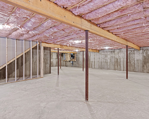 floor-insulation-hanover-pa Pink insulation installed under flooring from basement.