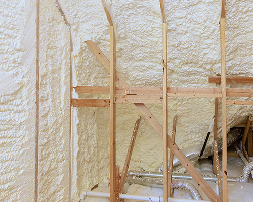 spray-foam-insulation-hanover-pa Newly installed white spray foam insulation in a residential attic.
